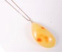 Lot 416 - A large butterscotch amber pendant, 6cm long...