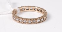 Lot 443 - A 9ct eternity ring, the white hardstone full...