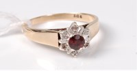 Lot 444 - A garnet and diamond cluster ring, the round...