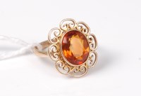 Lot 450 - A citrine ring, the oval citrine in a rubover...