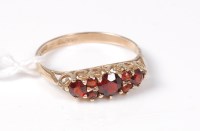 Lot 460 - A 9ct garnet ring, the three round garnets set...