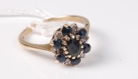 Lot 463 - A 9ct sapphire and diamond cluster ring, the...