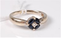 Lot 473 - An 18ct sapphire and diamond ring, the central...