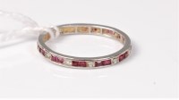 Lot 489 - A ruby and diamond eternity ring, each square...