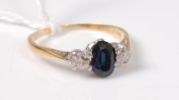 Lot 492 - An 8ct deep blue/green sapphire and diamond...