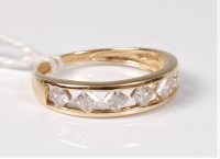 Lot 494 - A 14ct CZ ring, the seven CZ's channel set to...