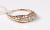 Lot 496 - A 9ct five stone diamond ring, with scrolled...