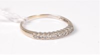 Lot 503 - A 9ct diamond half hoop ring, total estimated...