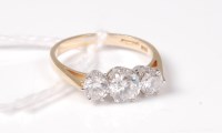 Lot 506 - A 14ct three stone CZ ring, the three slightly...