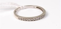 Lot 508 - A 9ct white gold half hoop eternity ring,...