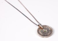 Lot 513 - A coin pendant set with a small green...