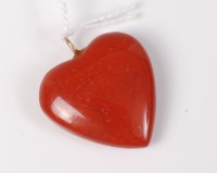 Lot 521 - A cornelian heart shaped pendant with yellow...