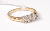 Lot 535 - A three stone diamond ring, the three round...