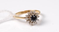 Lot 540 - A sapphire and diamond cluster ring, the round...