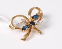 Lot 548 - A sapphire and diamond bow brooch, the three...