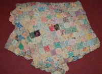 Lot 819 - An early 20th century hand woven patchwork quilt