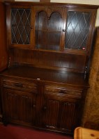 Lot 1137 - A reproduction moulded oak linenfold dresser...