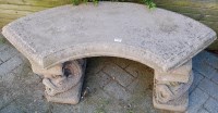 Lot 1158 - A reconstituted stone garden seat of curved...