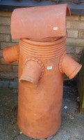 Lot 1159 - A terracotta circular chimney top with further...