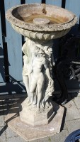 Lot 1176 - A reconstituted stone circular pedestal bird...