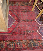 Lot 1184 - A Persian woollen red ground rug having a...