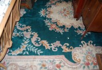 Lot 1186 - A modern Chinese Superwash green ground carpet...