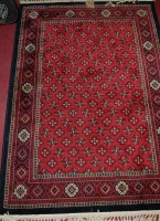 Lot 1190 - A Persian style woollen red ground Tabriz...