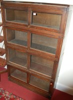 Lot 1199 - A 1930s oak four section stacking bookcase...