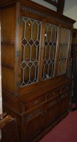 Lot 1207 - A contemporary Old Charm moulded oak display...