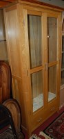 Lot 1210 - A contemporary light oak double door glazed...