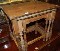 Lot 1232 - A moulded oak nest of three occasional tables,...