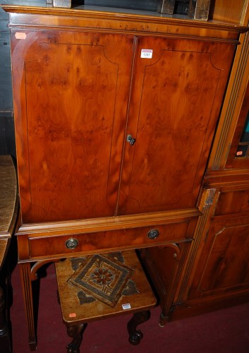 Lot 1283 - A reproduction yew wood double door drinks...