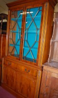 Lot 1285 - A Georgian style yew wood bookcase cupboard,...