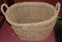 Lot 1303 - A pair of rattan interwoven twin handled oval...