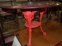 Lot 1362 - A red painted cast iron based and hardwood...