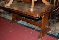 Lot 1374 - A moulded oak drawleaf dining table, raised on...