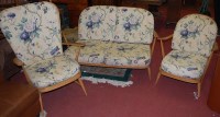 Lot 1380 - A suite of Ercol blond elm stickback lounge...