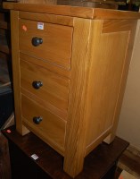 Lot 1453 - A contemporary elm three drawer bedside chest,...