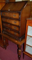 Lot 1466 - A reproduction mahogany slopefront four drawer...