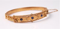 Lot 2501 - A sapphire and diamond hinged bangle, the...