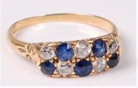 Lot 2513 - A sapphire and diamond ring, the two rows of...