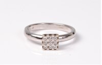 Lot 2516 - An 18ct white gold diamond ring, the nine...
