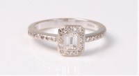 Lot 2521 - An 18ct diamond ring, the central emerald cut...