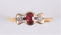 Lot 2524 - A ruby and diamond ring, the central oval ruby...