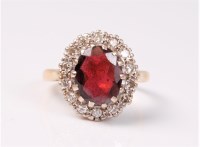Lot 2526 - An 18ct garnet and diamond cluster ring, the...