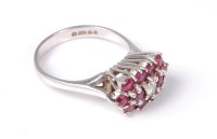 Lot 2533 - An 18ct ruby and diamond ring, the three rows...