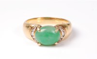Lot 2536 - A jade and diamond ring, the oval jade...