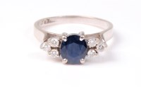 Lot 2539 - A sapphire and diamond ring, the round...
