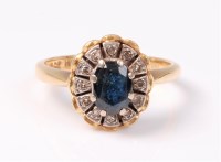 Lot 2541 - A sapphire and diamond cluster ring, the oval...
