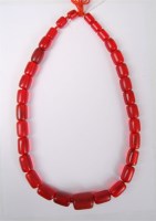 Lot 2601 - A faux 'cherry amber' necklace, the oblong...